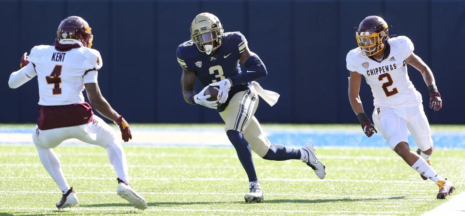 Akron wide receiver Daniel George runs after a catch between Central Michigan defensive backs Donte Kent (4) and Ronald Kent Jr. (2) on Oct. 15, 2022.