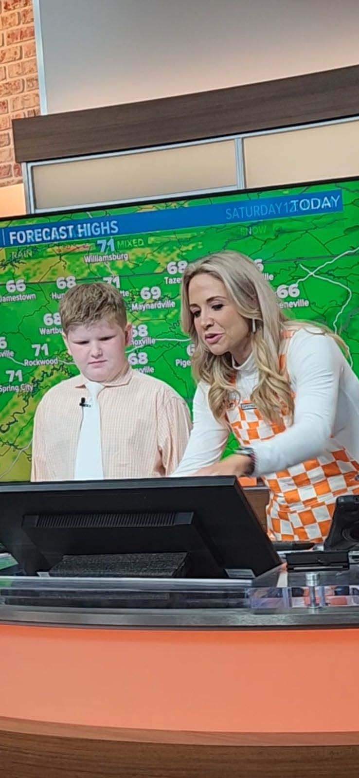 Lennon Kennedy listens intently to instructions from WBIR Channel 10 morning meteorologist Rebecca Sweet, March 29, 2024.