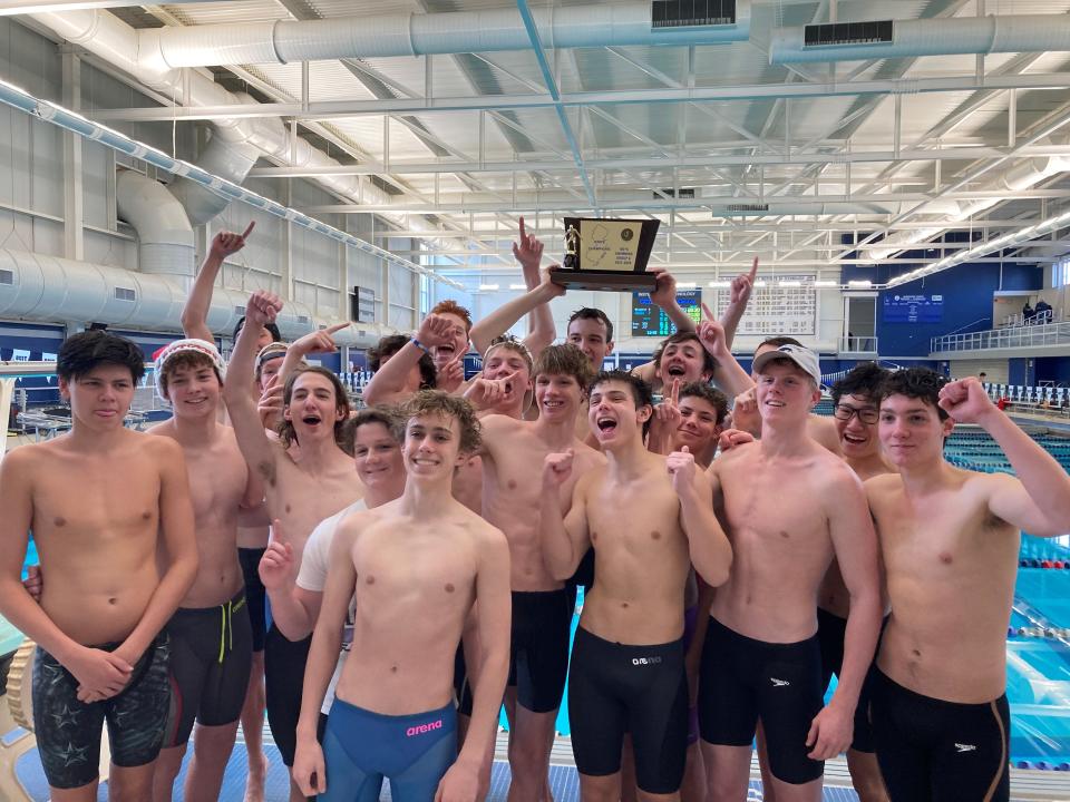 The Haddonfield boys swim team celebrates after defeating Holmdel to win its third straight NJSIAA Public C title.
