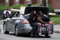 People participate in a protest march, Friday, Sept. 25, 2020, in Louisville. Breonna Taylor's family demanded Friday that Kentucky authorities release all body camera footage, police files and the transcripts of the grand jury hearings that led to no charges against police officers who killed the Black woman during a March drug raid at her apartment. (AP Photo/Darron Cummings)