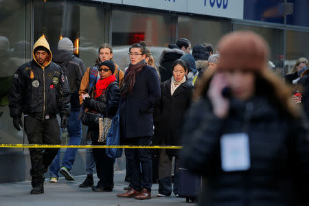 People look on from behind a police tape outside the New York Port Authority Bus Terminal after reports of an explosion in New York City, New York, U.S., December 11, 2017. REUTERS/Lucas Jackson