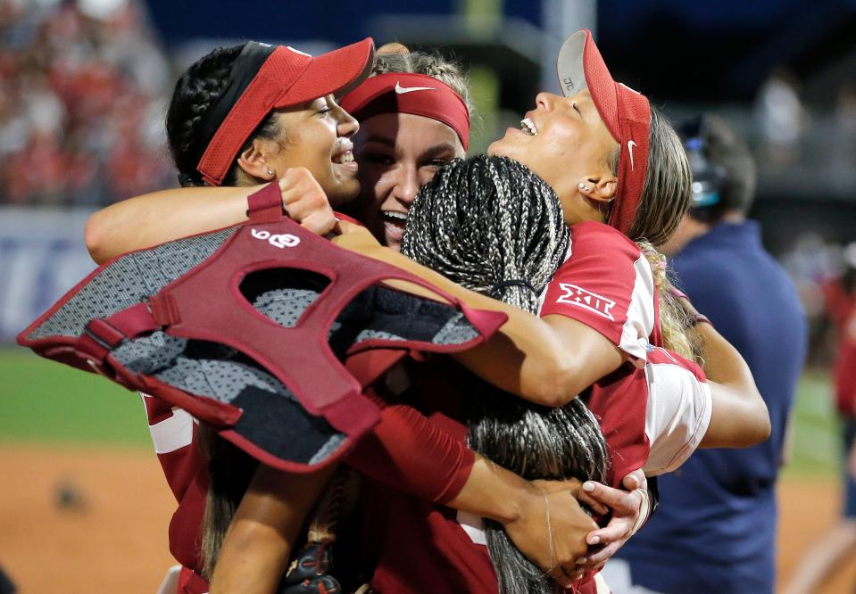 Oklahoma's Tiare Jennings (23), Kinzie Hansen (9), Rylie Boone (0) and Jayda Coleman (24) celebrate following the second game of the Women's College World Championship Series between the Oklahoma Sooners and Florida State at USA Softball Hall of Fame Stadium in Oklahoma City, Thursday, June, 8, 2023.