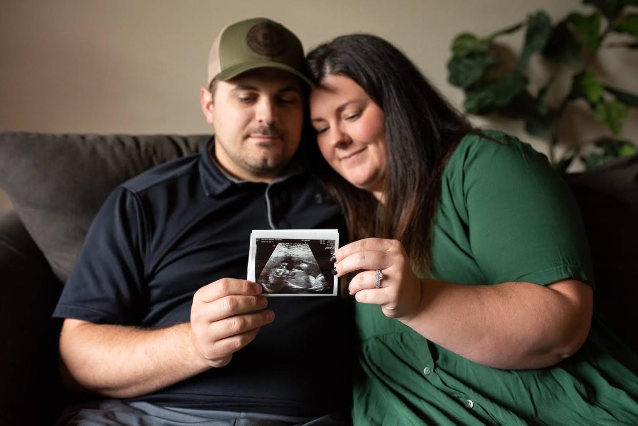 Magon Hoffman's life was in danger and her unborn daughter wouldn't survive. She had to drive 600 miles for an abortion. Hoffman and her husband, Lane, are seen holding an ultrasound image.