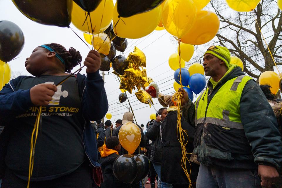 Community members gather Monday, Jan. 16, 2023, for a balloon release and memorial in honor of the late Richard Donnell Hamilton, or Coach Nell as he was known to the Indy Steelers youth football program. According to the Indiana State Police, Hamilton was shot during a road rage incident last week. 