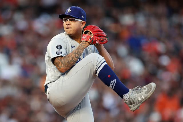 <p>Ezra Shaw/Getty</p> Julio Urias #7 of the Los Angeles Dodgers winds up for a pitch