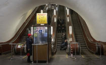 People gather in a subway station being used as a bomb shelter during a Russian rocket attack in Kyiv, Ukraine, Thursday, Jan. 26, 2023. (AP Photo/Efrem Lukatsky)