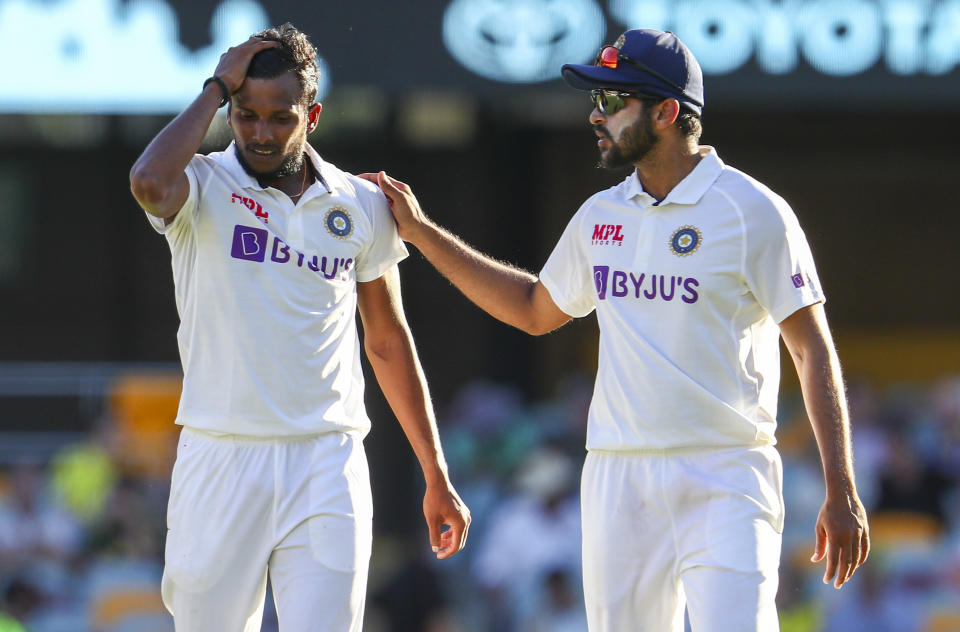 India's Thangarasu Natarajan, left, and India's Shardul Thakur talk during play on the first day of the fourth cricket test between India and Australia at the Gabba, Brisbane, Australia, Friday, Jan. 15, 2021. (AP Photo/Tertius Pickard)