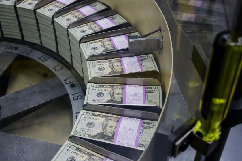 Packs of freshly printed 20 USD notes are processed for bundling and packaging at the US Treasury's Bureau of Engraving and Printing in Washington, DC July 20, 2018. - The dollar slid against the euro and pound on Friday, July 20, 2018, as US President Donald Trump adopted an aggressive posture on trade and foreign exchange, stoking talk of a currency war in addition to a trade war. (Photo by Eva HAMBACH / AFP) (Photo credit should read EVA HAMBACH/AFP via Getty Images)