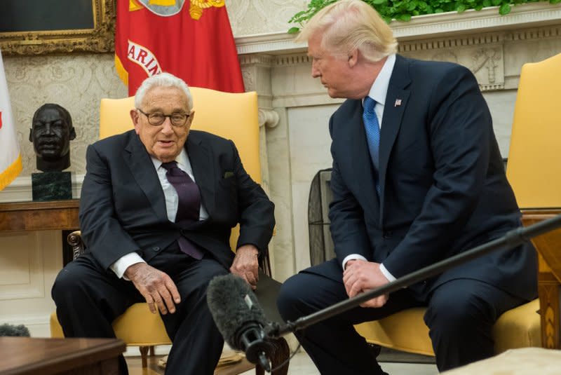 Former Secretary of State Henry Kissinger (L) speaks to the media during a meeting with President Donald Trump in the Oval Office at the White House on October 10, 2017. File photo by Kevin Dietsch/UPI