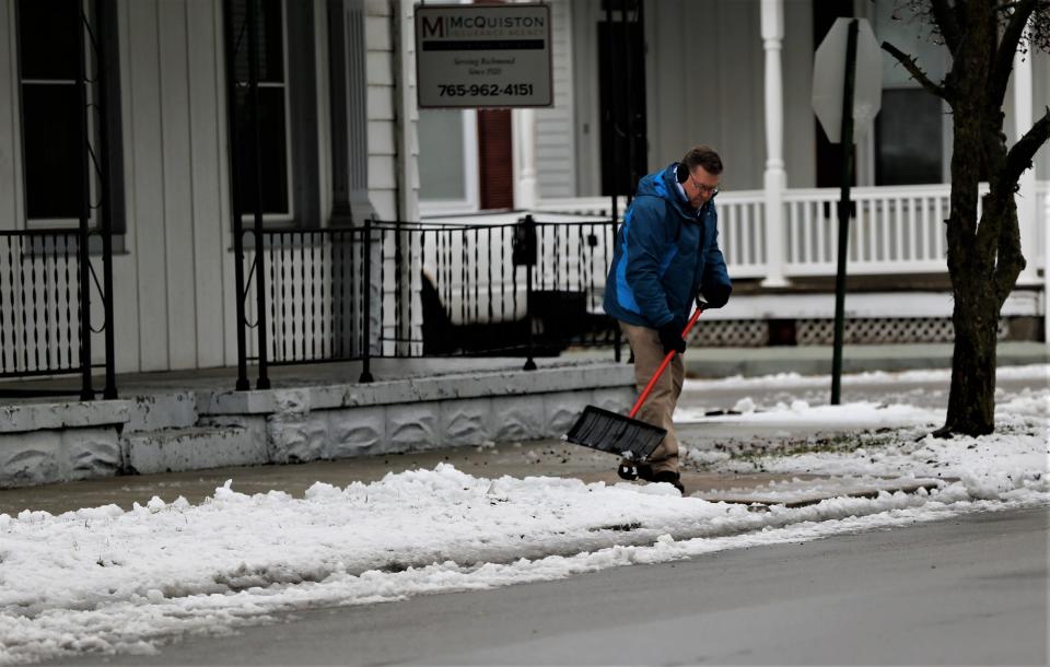 A man shovels his sidewalk on South 4th Street Jan. 25, 2023.