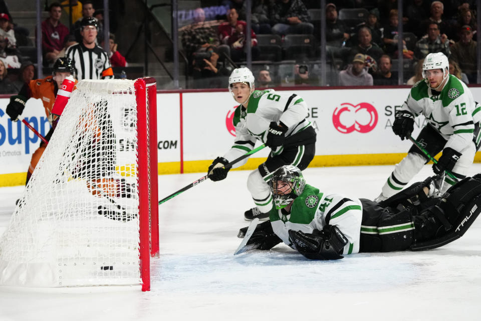 Dallas Stars goaltender Scott Wedgewood (41) gives up a goal to Arizona Coyotes defenseman Juuso Valimaki, back left, as Stars center Radek Faksa (12) and defenseman Nils Lundkvist (5) watch during the third period of an NHL hockey game in Tempe, Ariz., Thursday, Nov. 3, 2022. The Stars won 7-2. (AP Photo/Ross D. Franklin)