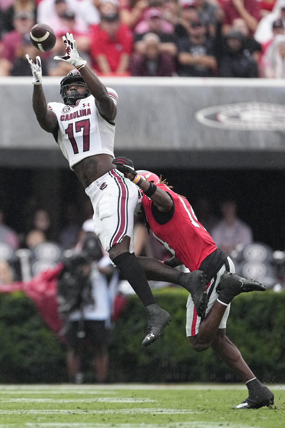 South Carolina wide receiver Xavier Legette (17) makes as catch as Georgia defensive back David Daniel-Sisavanh (14) defends during the first half of an NCAA college football game Saturday, Sept. 16, 2023, Ga. (AP Photo/John Bazemore)