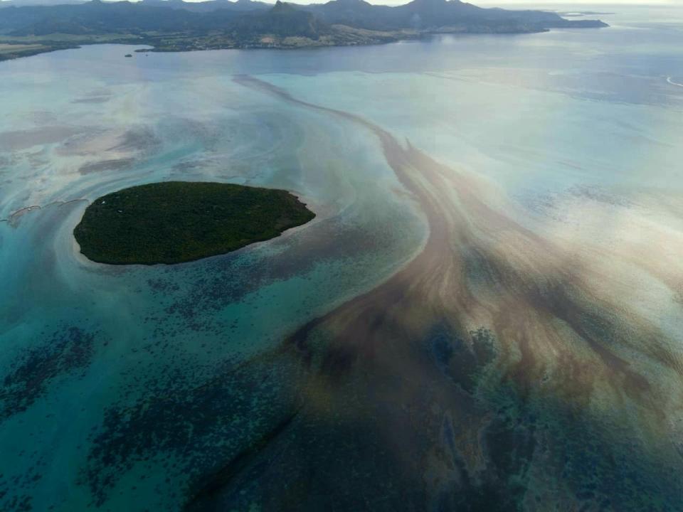 This photo provided by the Mauritian Wildlife Foundation Ministry shows oil leaking from the MV Wakashio, a bulk carrier ship that recently ran aground off the southeast coast of Mauritius, Monday Aug. 10, 2020. The Indian Ocean island of Mauritius has declared a "state of environmental emergency" after the Japanese-owned ship that ran aground offshore days ago began spilling tons of fuel. (Nik Cole/Mauritian Wildlife Foundation via AP)