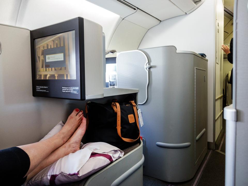 A woman's bare feet propped up on the business class cabin for Iberia Airlines.