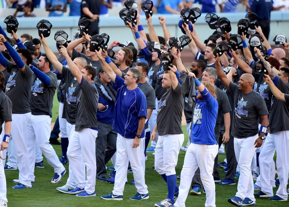 <p>The Los Angeles Dodgers tip their hats to announce Vin Scully who retires at the end of the season after a 4-3 win over the Colorado Rockies during the tenth inning at Dodger Stadium on September 25, 2016 in Los Angeles, California. (Photo by Harry How/Getty Images) </p>