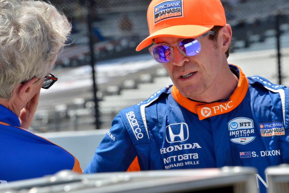 Chip Ganassi Racing driver Scott Dixon (9) talks with a member of his team Friday, May 13, 2022, during practice for the GMR Grand Prix at Indianapolis Motor Speedway. 