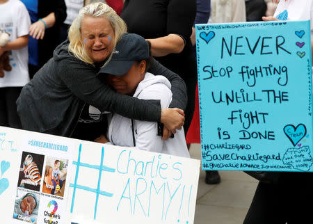 Supporters of Charlie Gard's parents react outside the High Court during a hearing on the baby's future, in London, Britain. REUTERS/Peter Nicholls