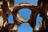 Sky is seen through the holes of the San Agustin church ceiling in the old village of Belchite, in northern Spain, October 3, 2016. REUTERS/Andrea Comas
