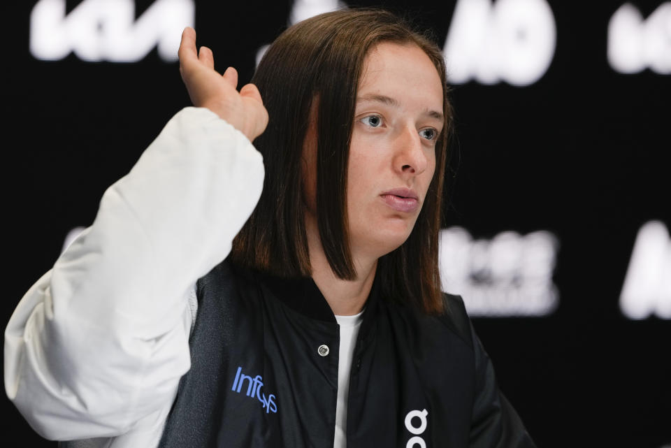 Poland's Iga Swiatek reacts during a press conference ahead of the Australian Open tennis championships at Melbourne Park, Melbourne, Australia, Friday, Jan. 12, 2024. (AP Photo/Mark Baker)