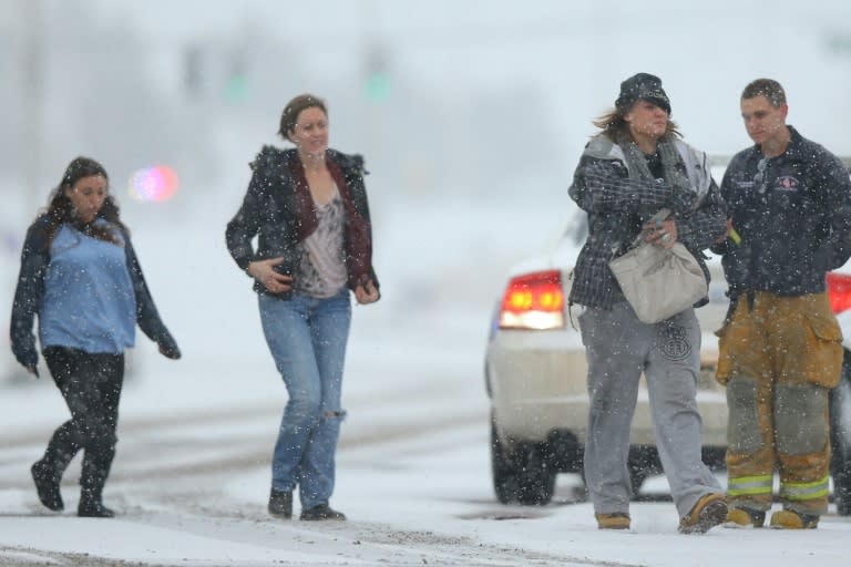 Hostages are escorted to an ambulance during an active shooter situation near a Planned Parenthood facility on November 27, 2015 in Colorado Springs, Colorado