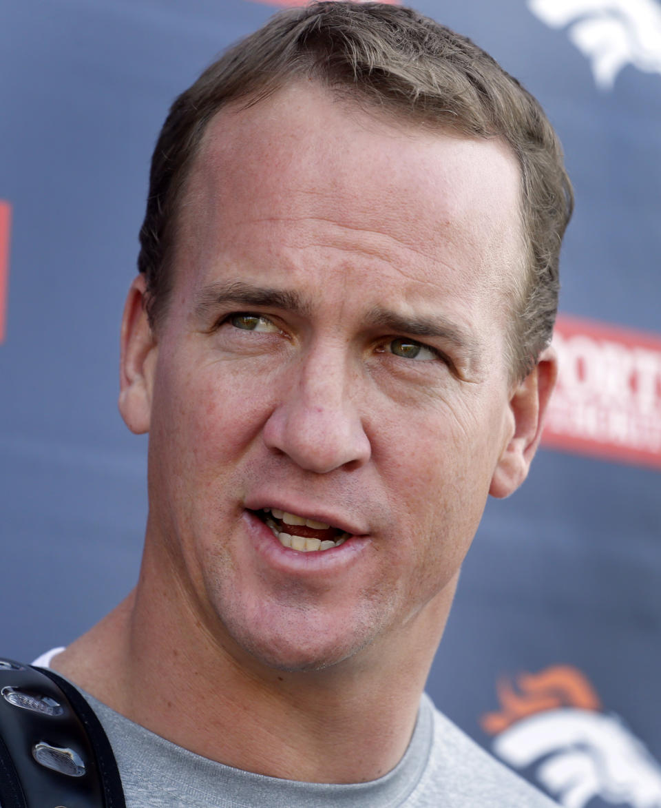 Denver Broncos quarterback Peyton Manning talks to the media after working out at the NFL football teams training facility in Englewood, Colo., on Monday, April 21, 2014. (AP Photo/Ed Andrieski)