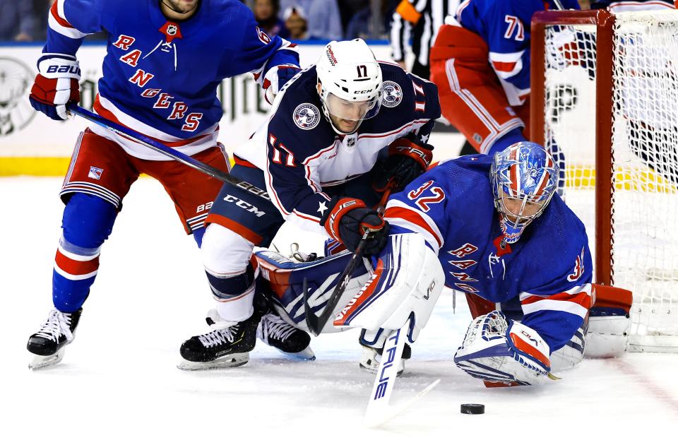 New York Rangers goaltender Jonathan Quick (32) makes a save against Columbus Blue Jackets right wing Justin Danforth (17) during the first period of an NHL hockey game, Sunday, Nov. 12, 2023, in New York. (AP Photo/Noah K. Murray)