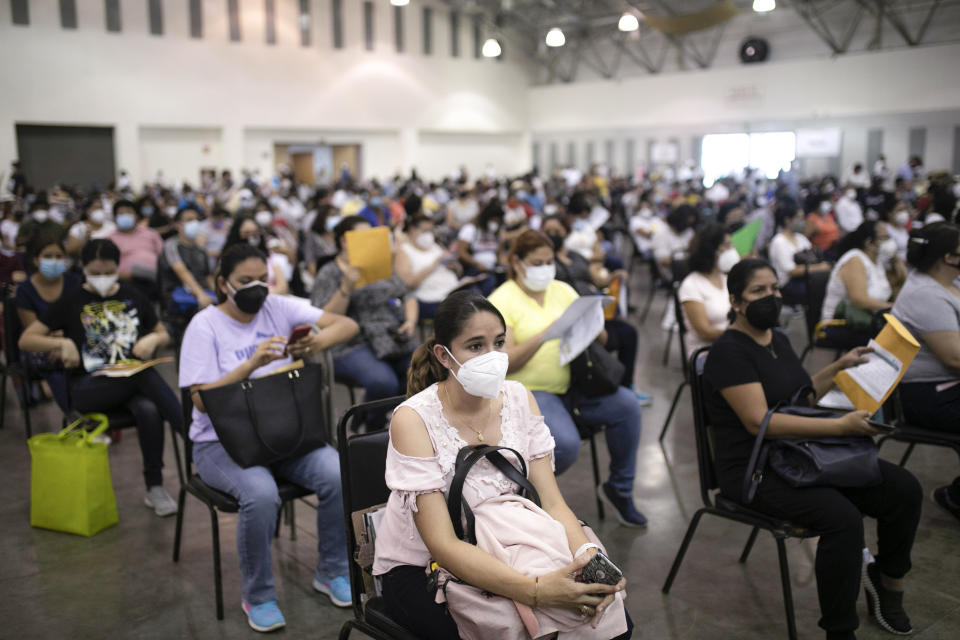 FILE - Education workers wait for their jab of the single-dose CanSino COVID-19 vaccine during a vaccination drive at the World Trade Center in Boca del Rio, Veracruz state, Mexico, April 20, 2021. On Monday, the U.S. will implement a new air travel policy to allow in foreign citizens who have completed a course of a vaccine approved by the Food and Drug Administration or the World Health Organization. That leaves people in Mexico, Hungary, Russia and elsewhere who received the non-approved Russian Sputnik V vaccine or the China-produced CanSino vaccine ineligible to board U.S.-bound flights. (AP Photo/Felix Marquez, File)