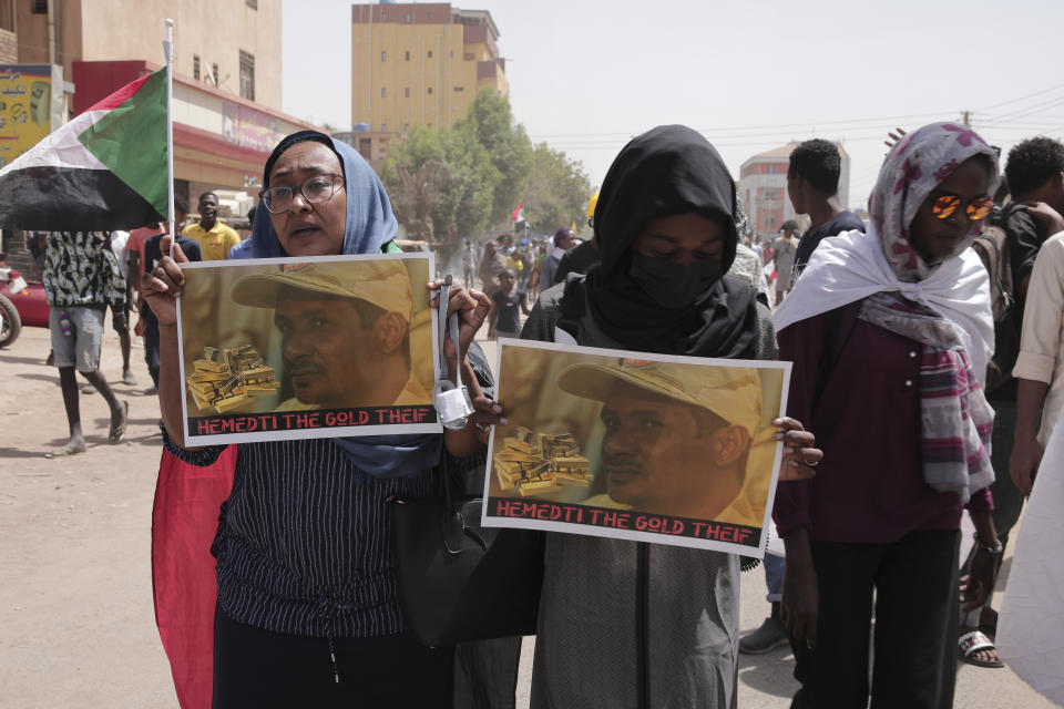 Sudanese anti-coup protesters take part in ongoing demonstrations against the military rule in Khartoum, Sudan, Monday, March.14, 2022. Women are holding photos of General Mohamed Hamdan Dagalo , generally referred to as Hemedti, a Deputy Chairman of the Transitional Military Council (TMC) following the 2019 Sudanese coup. (AP Photo/Marwan Ali)