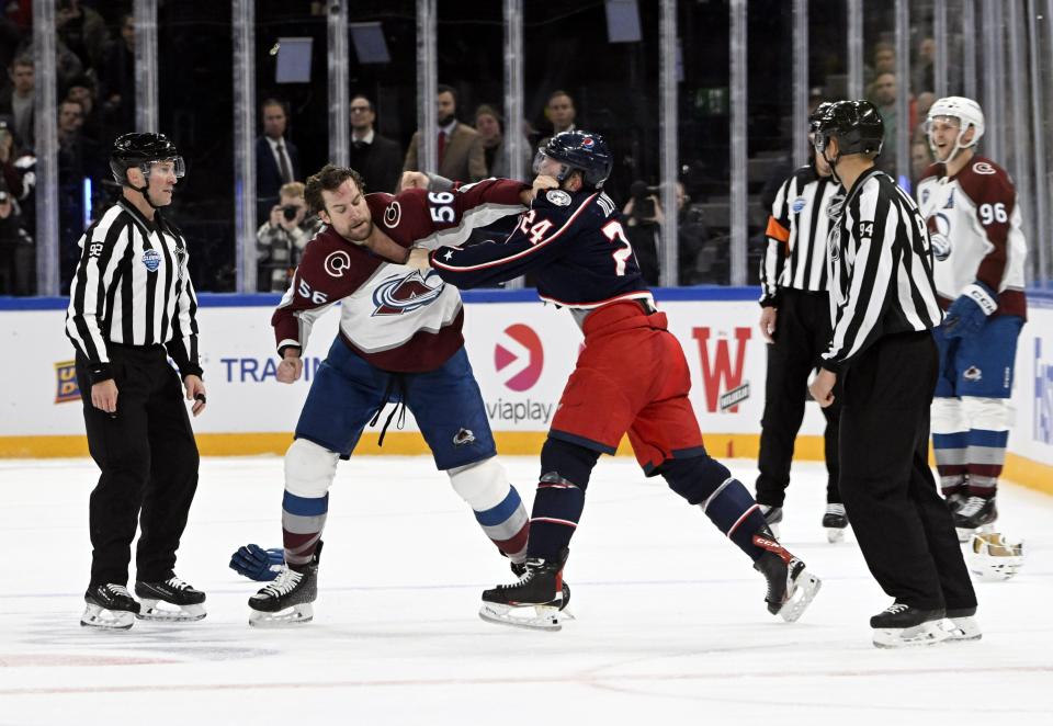 Kurtis MacDermid, centre left of Colorado Avalanche and Mathieu Olivier of Columbus Blue Jackets exchange punches, during the 2022 NHL Global Series ice hockey match between Colorado Avalanche and Columbus Blue Jackets in Tampere, Finland, Saturday, Nov. 5, 2022. (Emmi Korhonen./Lehtikuva via AP)