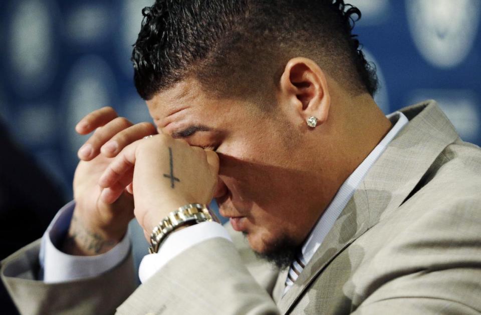 Seattle Mariners' Felix Hernandez dries his eyes during a news conference, Wednesday, Feb. 13, 2013, in Seattle. Hernandez, who repeatedly said, "I will not disappoint anybody," signed a seven-year contract with the Mariners that makes him the highest-paid pitcher in baseball. The new deal will be worth $175 million. (AP Photo/Elaine Thompson)