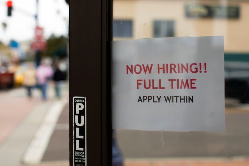 FILE PHOTO: A retail store advertising a full time job on its open door in Oceanside, California