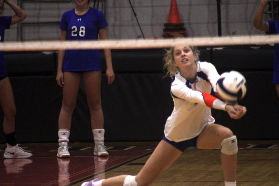 Bolles senior Grace Albaugh (1) lunges for a dig during warm-ups before a Sept. 8 match at Bishop Kenny.