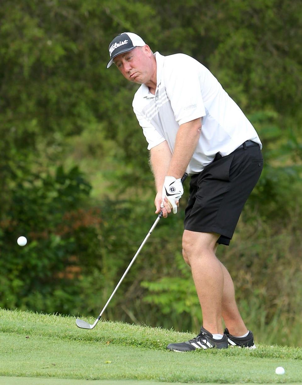 New BNL boys head golf coach Jeff Hein chips onto a green at Otis Park during the 2021 Men's City Championship.