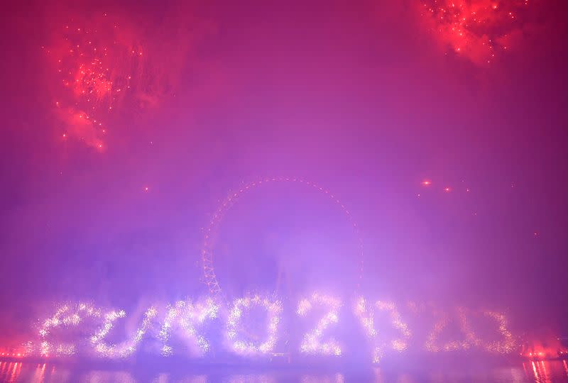 Fireworks explode around the London Eye wheel during New Year celebrations in central London