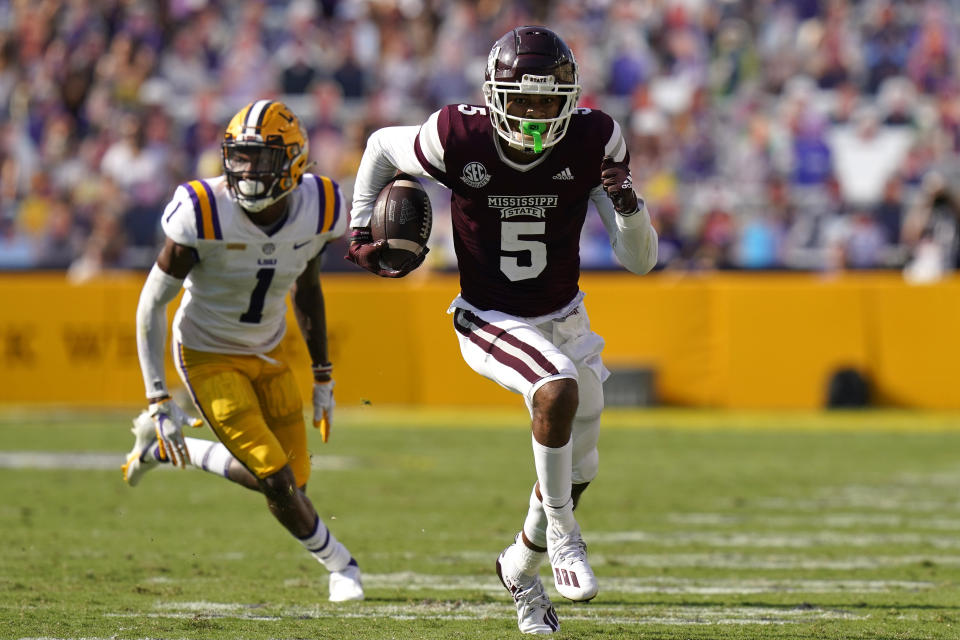 Mississippi State wide receiver Osirus Mitchell (5) carries on a touchdown reception as he is pursued by LSU cornerback Eli Ricks (1) in the first half an NCAA college football game in Baton Rouge, La., Saturday, Sept. 26, 2020. Mississippi State won 44-34. (AP Photo/Gerald Herbert)