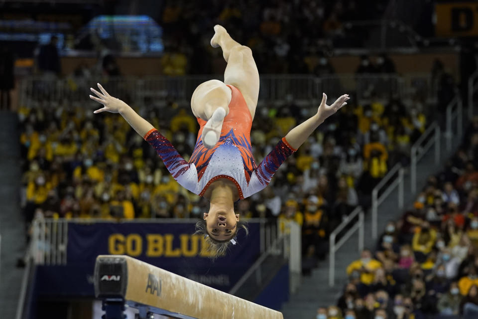 Auburn gymnast Sunisa Lee performs during a meet at the University of Michigan, Saturday, March 12, 2022, in Ann Arbor, Mich. A record crowd came out to watch Lee, the reigning Olympic champion, and Auburn take on defending national champion Michigan. The arrival of Lee and several of her Olympic teammates at the collegiate level is helping fuel a spike in interest and participation in NCAA women's gymnastics. (AP Photo/Carlos Osorio)
