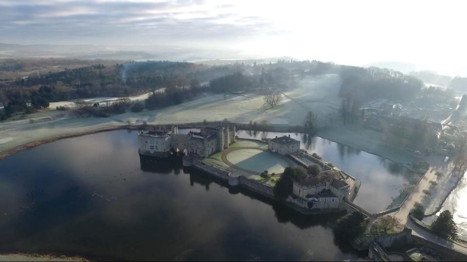 <p>Foggy air lingers over Leeds castle, which can be seen reflected in a glassy lake from 400ft in the air.</p>