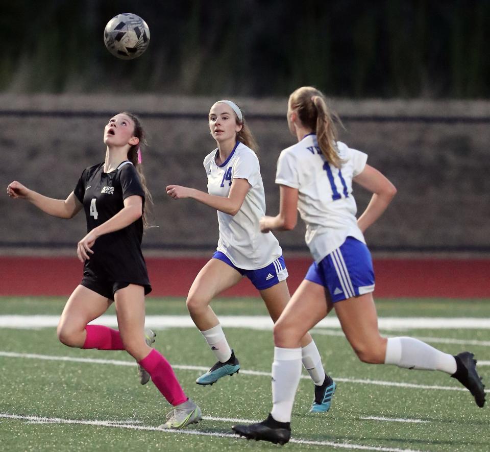 Klahowya's Raven Stoner takes control of a header (4) ahead of Bellevue Christian's Cassie Clauder (14) and Charlotte Aitken (11) on Thursday, Oct. 6, 2022.