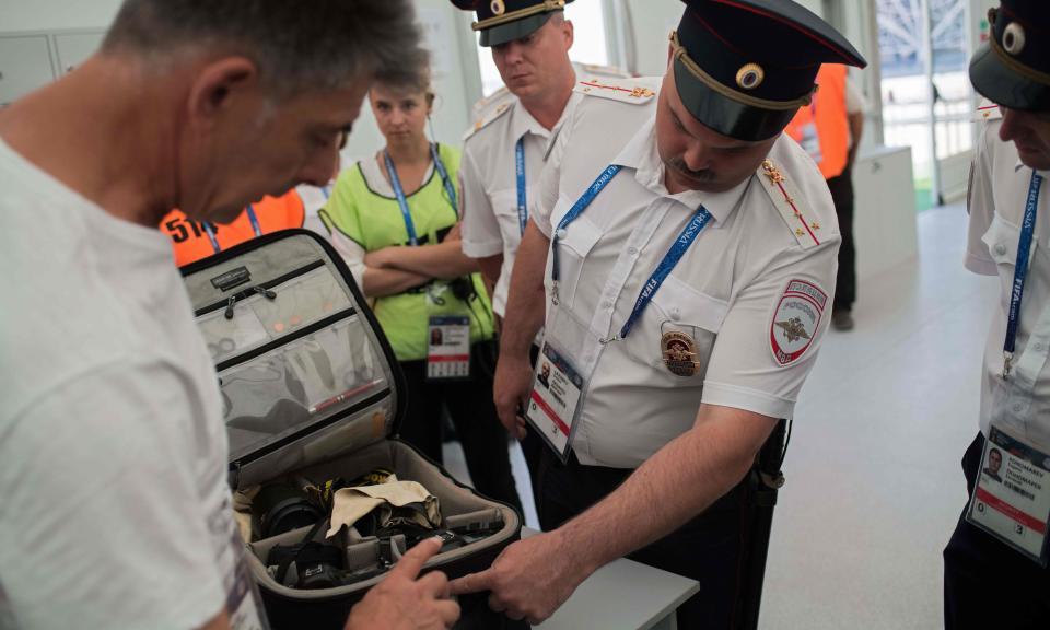 Security officials search a photographer’s equipment bag inside the Volgograd Arena on Saturday.