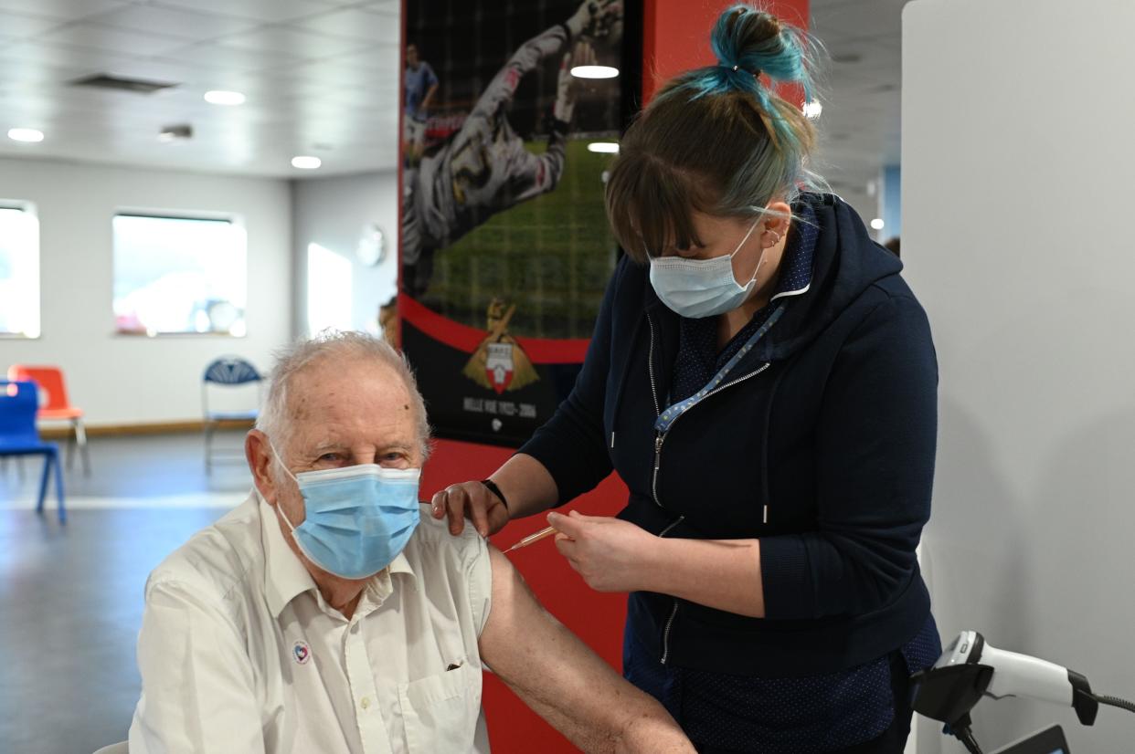 <p>Nurse Hannah Flynn administers the Oxford/AstraZeneca Covid-19 vaccine to a patient at a temporary vaccination centre in the Keepmoat Stadium in Doncaster</p> (AFP/Getty)