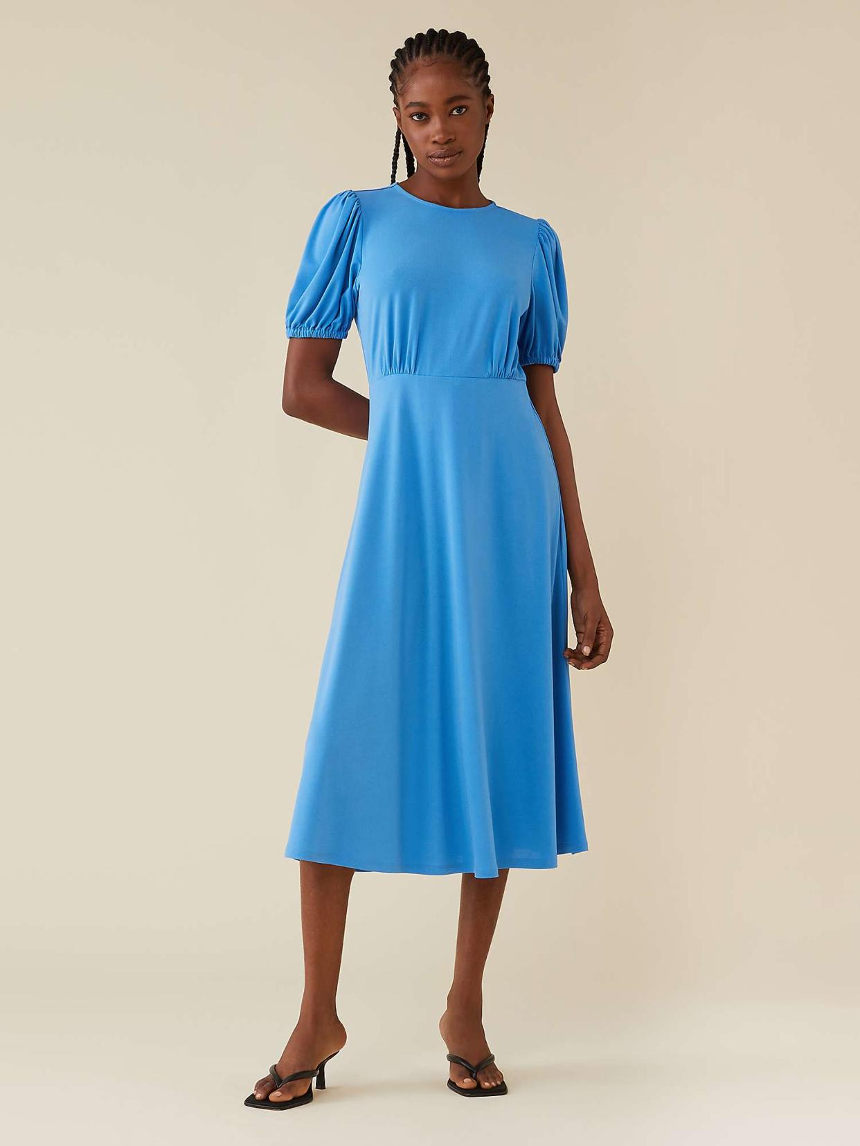The flattering midi dress is also available in a forget-me-not blue. (John Lewis)
