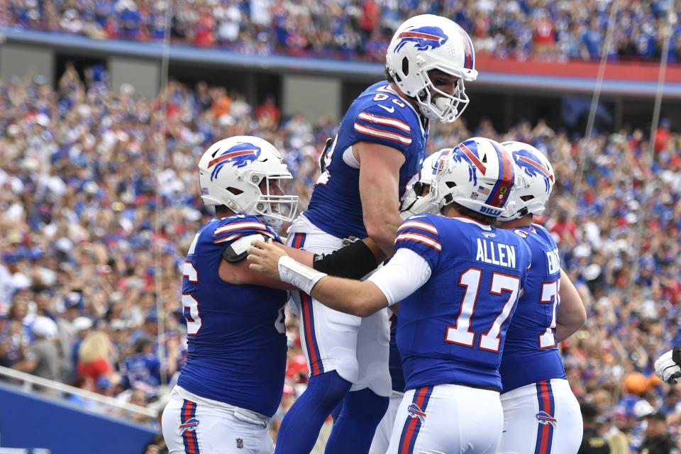 Buffalo Bills quarterback Josh Allen (17) and Dawson Knox celebrate with teammates after they connect for a touchdown during the first half of an NFL football game against the Las Vegas Raiders, Sunday, Sept. 17, 2023, in Orchard Park, N.Y. (AP Photo/Adrian Kraus)