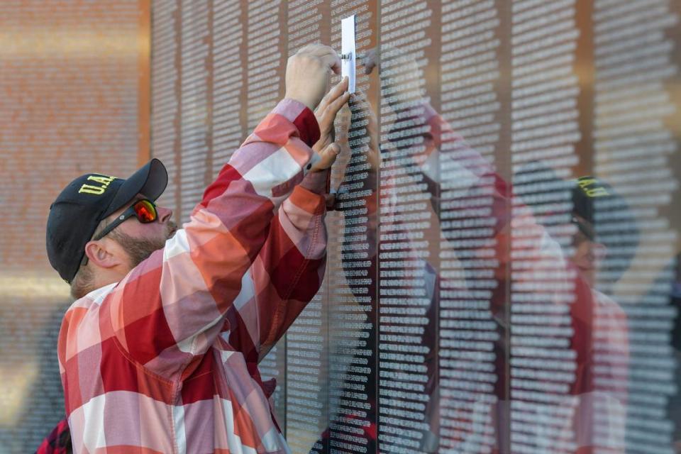 Ryne Wangler traces the name of his great-great uncle Lossy R. Wangler from the new Dignity Memorial Vietnam Wall, which was dedicated March 29, 2024, at the National Infantry Museum in Columbus, Georgia.