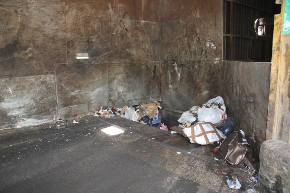 The "pit" where trash goes to be compacted into the dump trailers. Trash is dumped onto the floor, then a bobcat pushes it into the pit where a hydraulic ram forces it into the trailer.