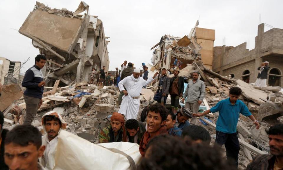 The body of woman is carried away from a house destroyed by a Saudi-led airstrike in Sanaa, Yemen, in August 2017.