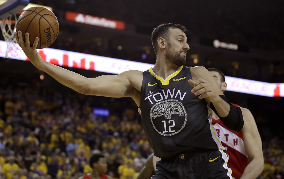 FILE - In this June 7, 2019, file photo, Golden State Warriors center Andrew Bogut (12) holds the ball against the Toronto Raptors during the second half of Game 4 of basketball's NBA Finals in Oakland, Calif. Bogut announced Tuesday, Dec. 1, 2020 that he is calling quits on his bid for an Olympic medal and has decided to retire after 15 years in professional basketball. (AP Photo/Ben Margot, File)