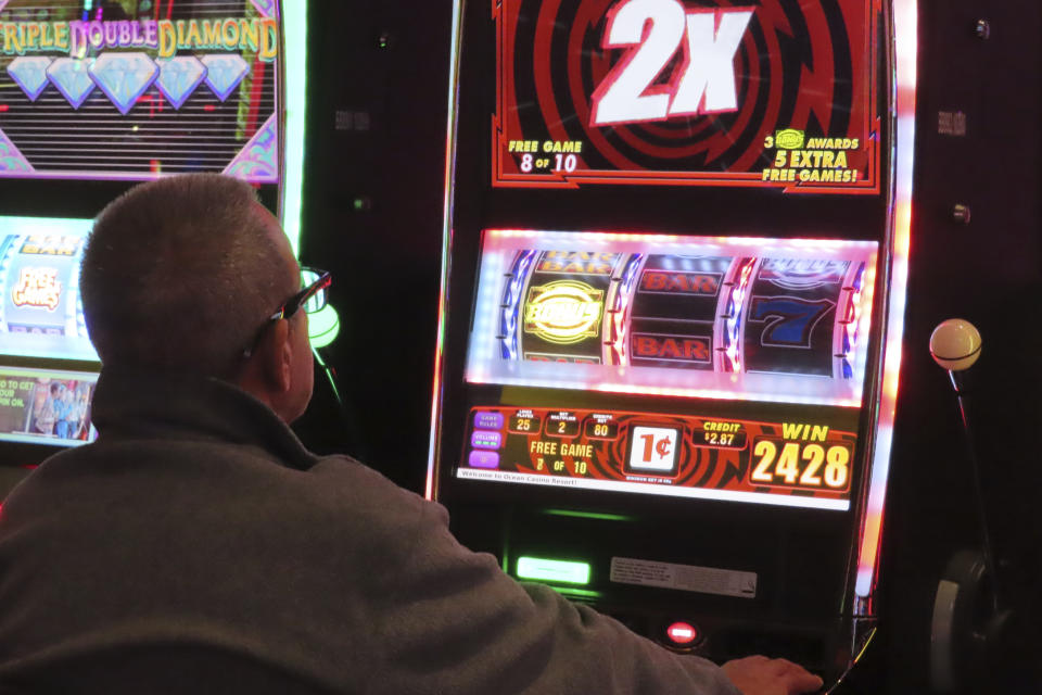 A gambler plays a slot machine at the Ocean Casino Resort in Atlantic City N.J. on Nov. 29, 2023. On March 15, 2024, New Jersey gambling regulators released figures showing Atlantic City's nine casinos, the three horse tracks that accept sports bets, and their online partners won over $461 million in February, an increase of 12% from February 2023. (AP Photo/Wayne Parry)