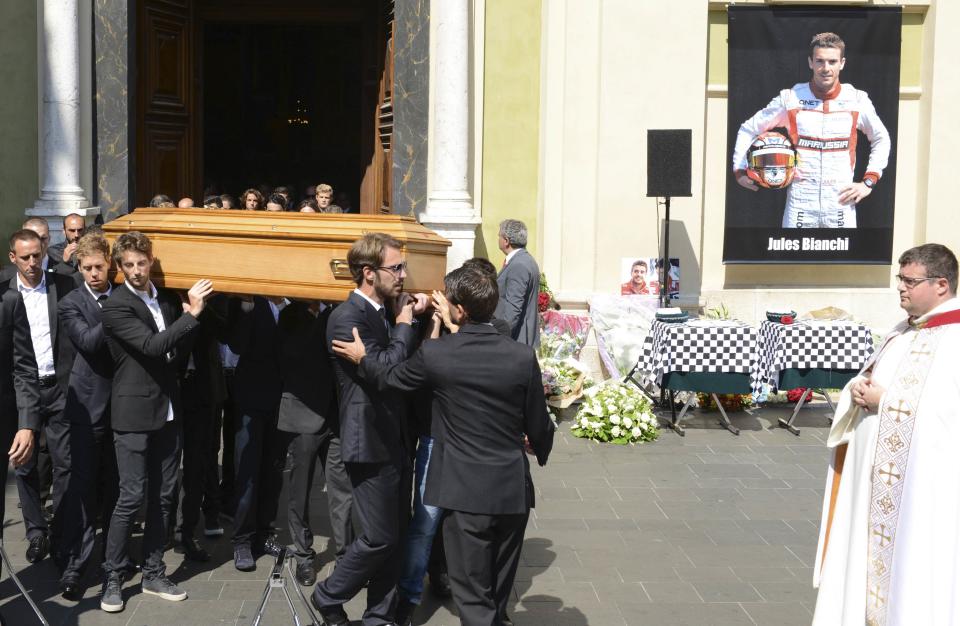 Formula One drivers Jean-Eric Vergne (front) and Romain Grosjean (3rdL), friends and relatives carry the coffin of late Marussia F1 driver Jules Bianchi during the funeral ceremony at the Sainte Reparate Cathedral in Nice, France, July 21, 2015. Bianchi, 25, died in hospital in Nice on Friday, nine months after his crash at Suzuka in Japan and without regaining consciousness. REUTERS/Jean-Pierre Amet