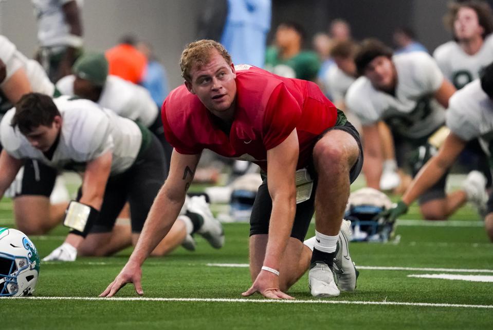 Tulane quarterback Michael Pratt (7) stretches during team practice ahead of the Cotton Bowl NCAA college football game, Thursday, Dec. 29, 2022, in Arlington, Texas. Tulane will face Southern California in the Cotton Bowl on Monday, Jan. 2, 2023. (AP Photo/Sam Hodde)