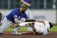 Houston Astros' Jeremy Pena (3) steals second base as Texas Rangers second baseman Marcus Semien loses the ball during the second inning of a baseball game Saturday, May 21, 2022, in Houston. (AP Photo/David J. Phillip)